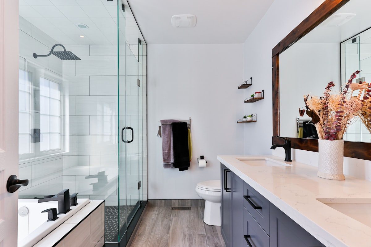 Modern bathroom with a frameless glass shower and dark vanity unit
