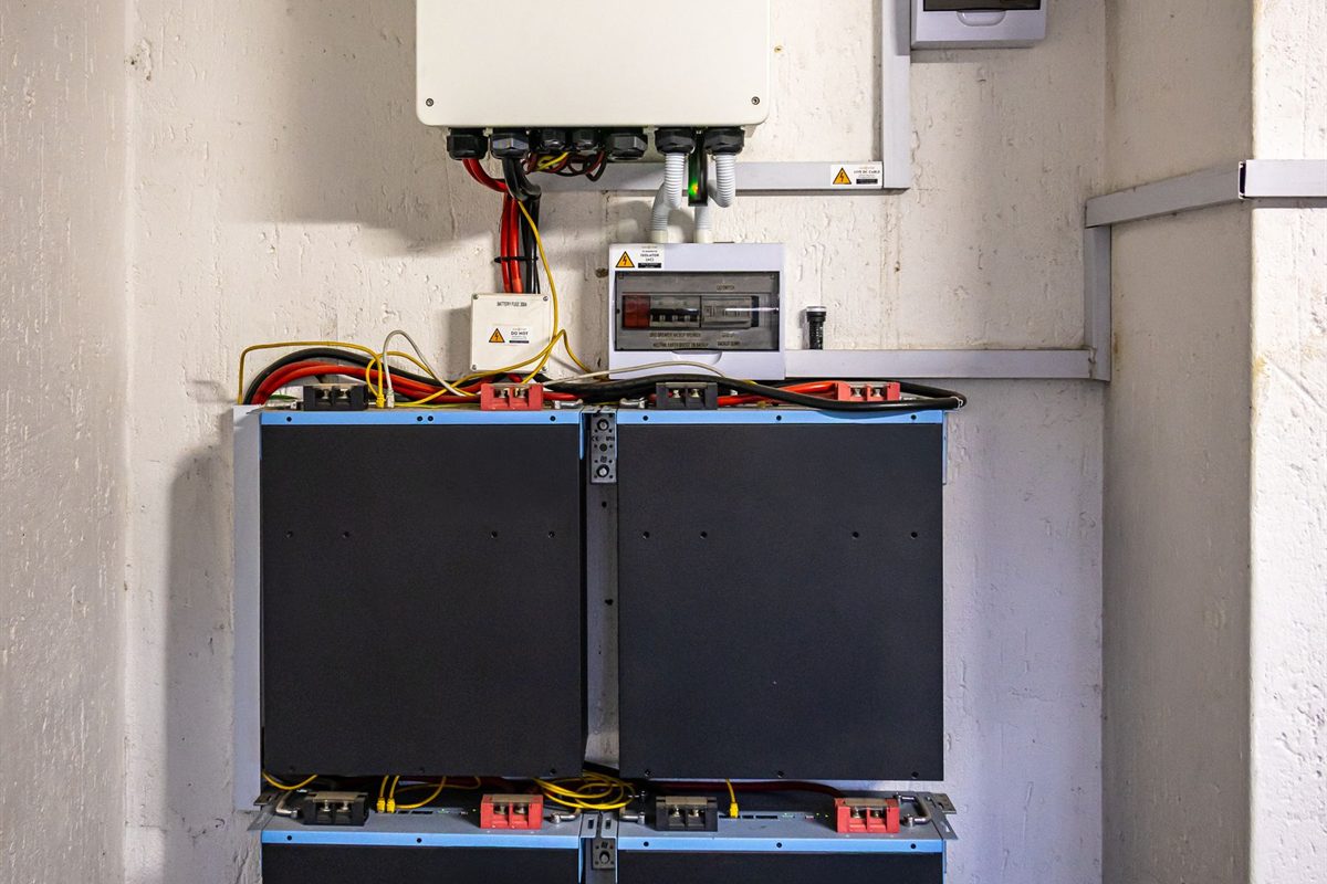 Hybrid inverter and lithium battery mounted on a garage wall